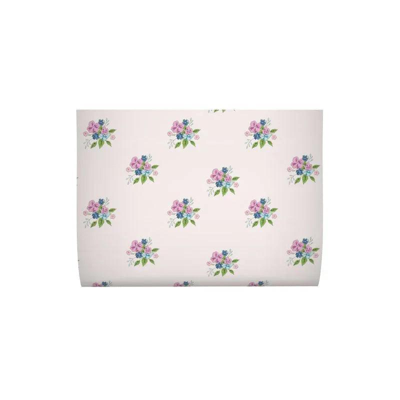 Pale pink gift wrap sheet with repeating floral bouquet pattern in pink, blue, and green.
