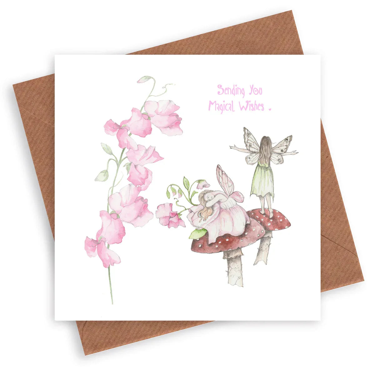 Greeting card featuring watercolor fairies on a toadstool, pink flowers, and 'Sending You Magical Wishes' text.