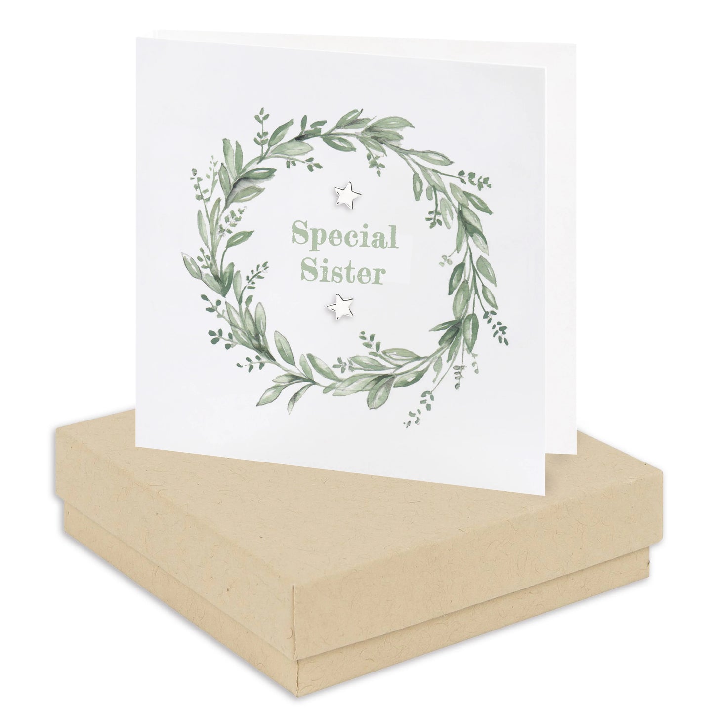 Special Sister greeting card with green wreath design and silver stars, displayed on gift box